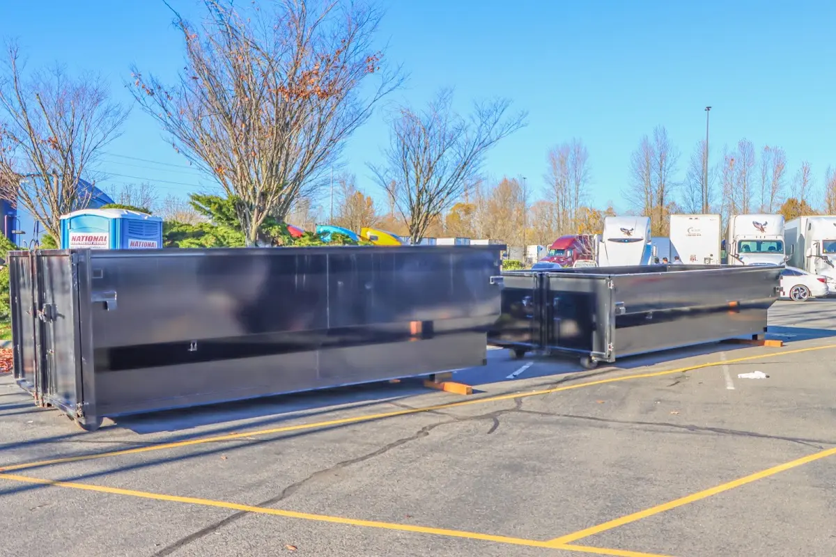 Professional dumpster rental service with roll-off container on residential driveway in Goldsboro